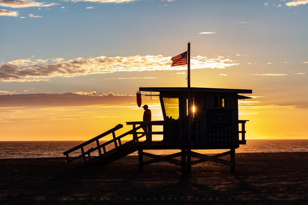 photo of lifeguard tower at sunset